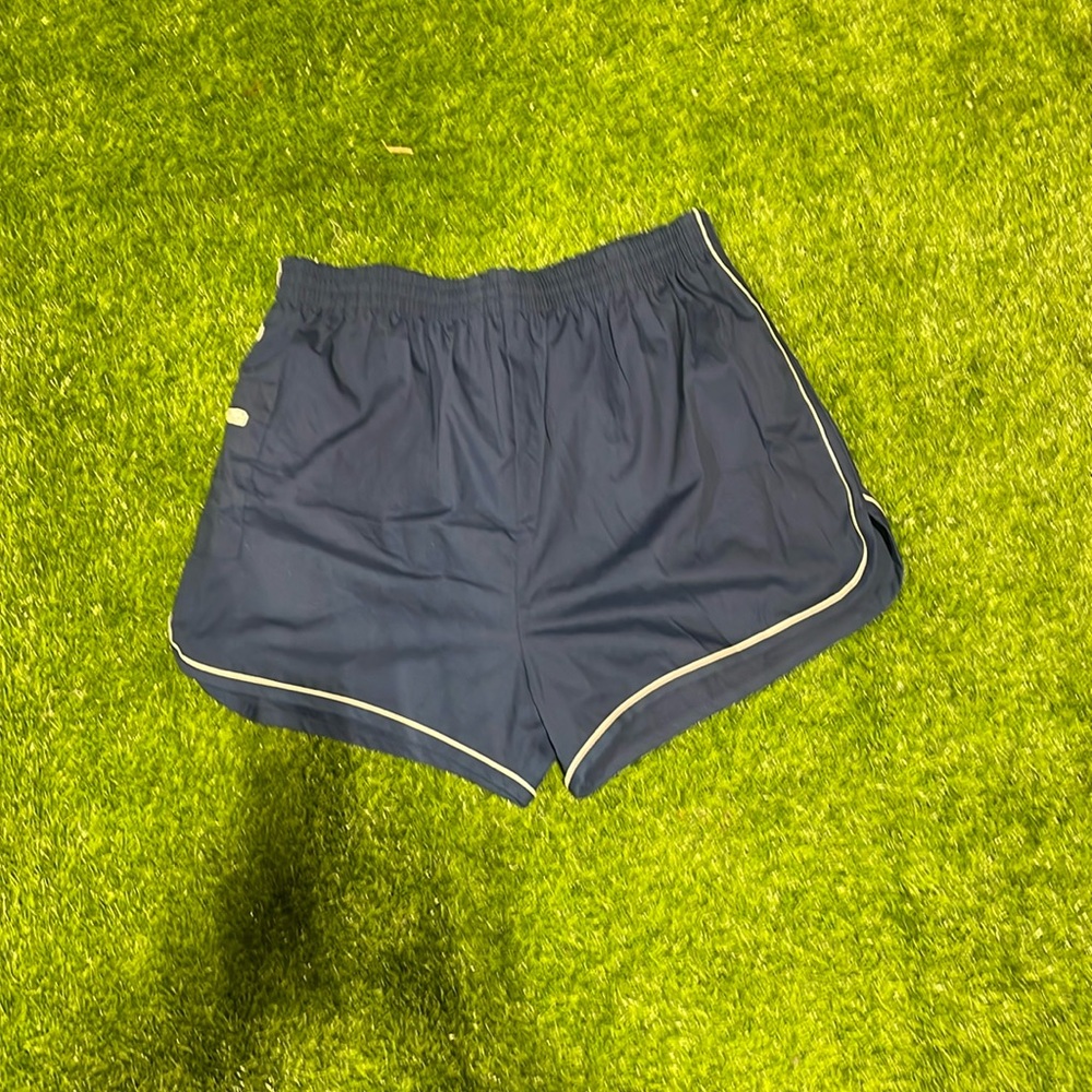 Men’s blue swim trunks with white piping and side zipper pocket